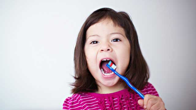 Small girl brushing her teeth