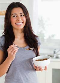 Happy girl eating healthy food