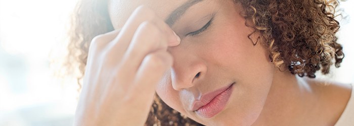 Girl holding her forehead due to sinus