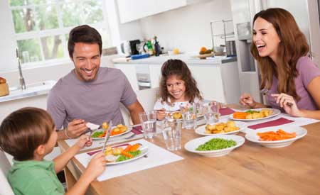 Happy family eating food on the dining table