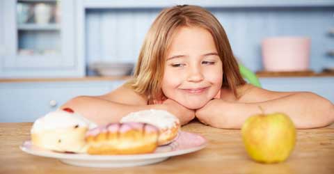 Small girl looking at the donuts