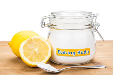 Spoonful of baking soda and lemon fruits for multiple holistic usages