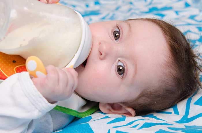 Baby drinking milk from bottle