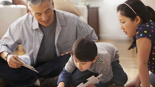 Kids playing with their father