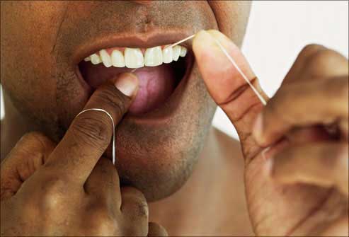 Man flossing teeth