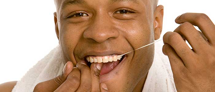 Man flossing his teeth