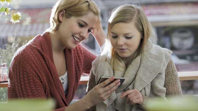 Mother and daughter watching mobile