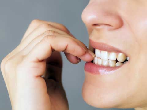 Woman biting her nails