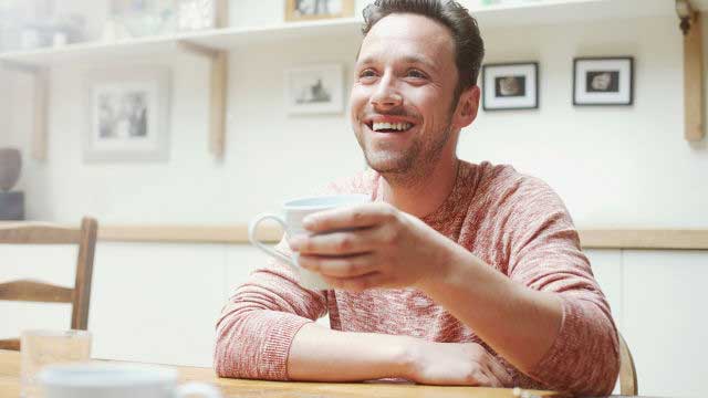 Young man holding coffee mug