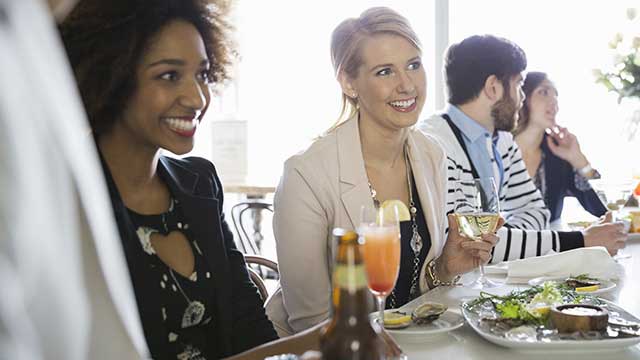 2 happy women eating in the restaurant