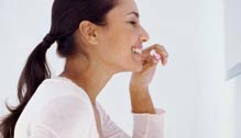 Women brushing her teeth