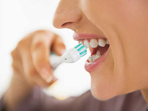 Woman brushing her teeth