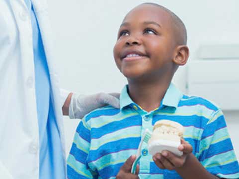 Small boy holding toothbrush