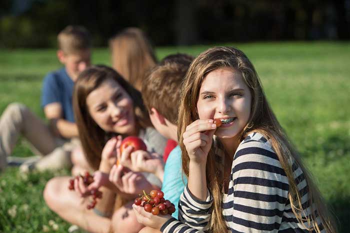 Girl eating berries in the garden